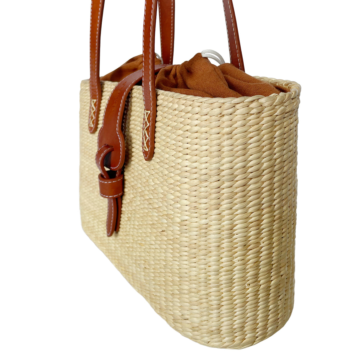Square basket bag with blue stripe lining poolside with summer essentials