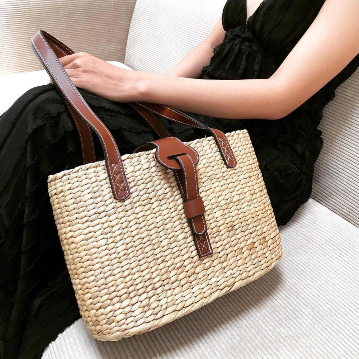 Basket bag worn on the shoulder with blue stripe lining visible