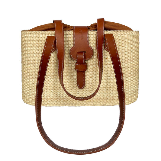 Square basket bag in natural water hyacinth straw with brown leather straps and blue stripe lining
