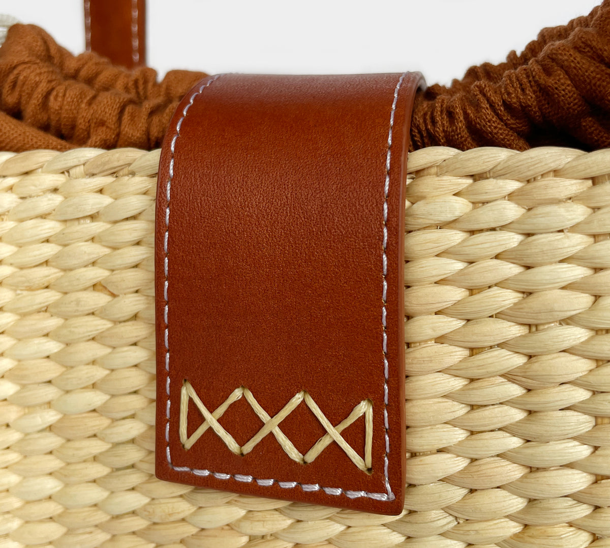 Close-up of the linen-cotton lining and braided straw rim